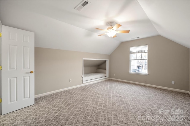 bonus room featuring lofted ceiling, light carpet, visible vents, and baseboards