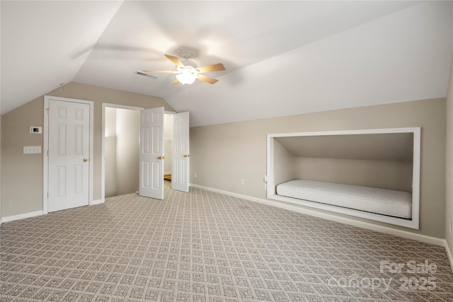 additional living space with baseboards, visible vents, a ceiling fan, lofted ceiling, and carpet floors