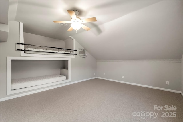 bonus room featuring carpet floors, a ceiling fan, an AC wall unit, vaulted ceiling, and baseboards