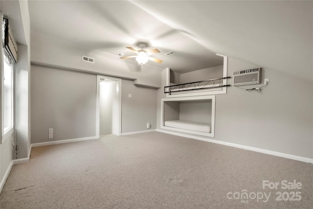 unfurnished living room with carpet floors, visible vents, baseboards, and a ceiling fan