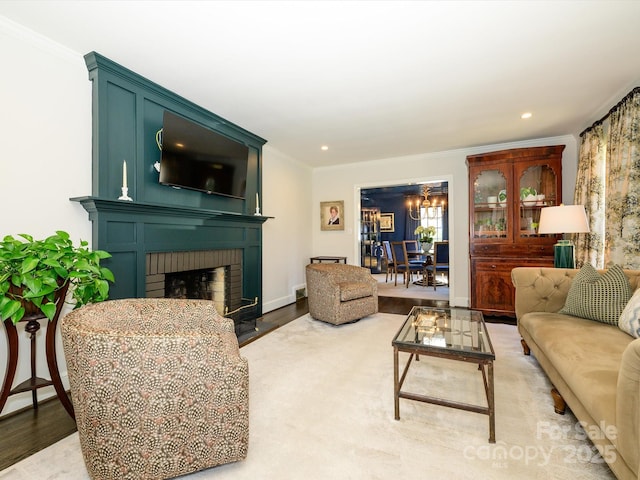 living room with recessed lighting, a fireplace, wood finished floors, baseboards, and ornamental molding