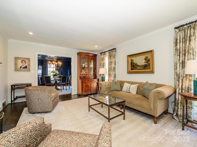 living area with a chandelier, recessed lighting, baseboards, ornamental molding, and light wood-type flooring