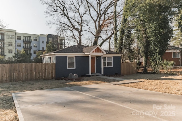 view of front of house with brick siding, crawl space, and fence