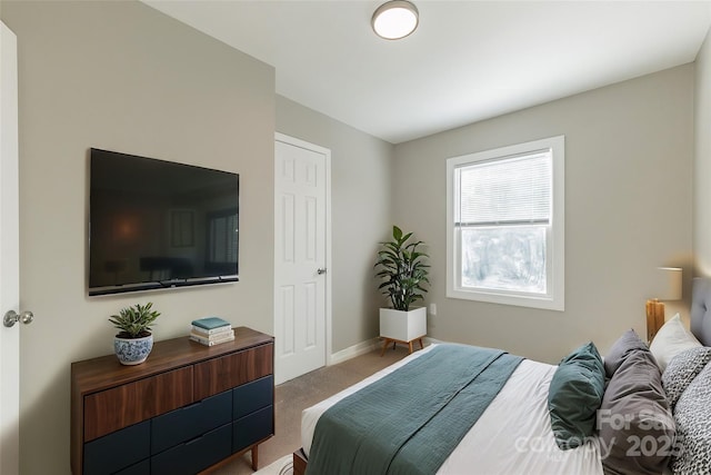 carpeted bedroom with baseboards