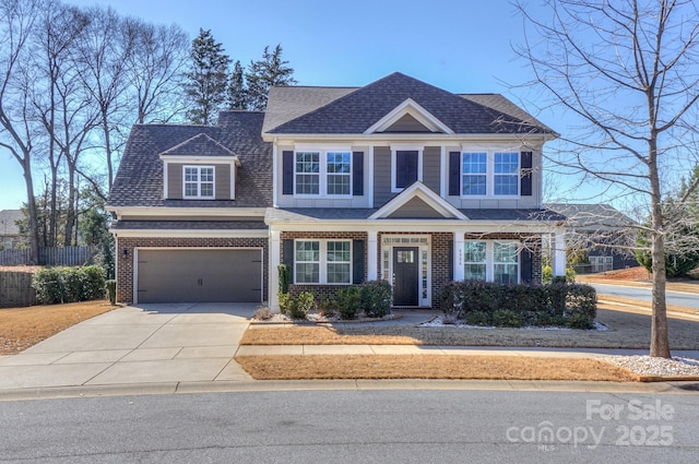 view of front of property with concrete driveway, brick siding, roof with shingles, and an attached garage