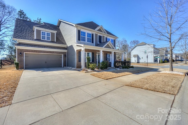 view of front of property with a garage, driveway, roof with shingles, and brick siding