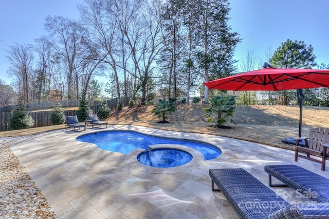 view of pool featuring a patio area, a fenced backyard, a fenced in pool, and an in ground hot tub