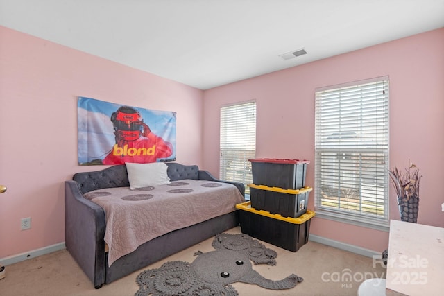 carpeted bedroom with multiple windows, visible vents, and baseboards