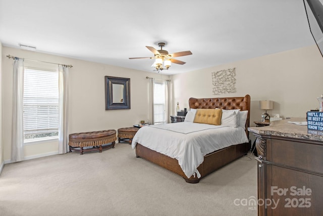 bedroom with ceiling fan, visible vents, and light colored carpet