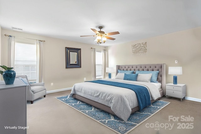 bedroom featuring a ceiling fan, visible vents, and baseboards