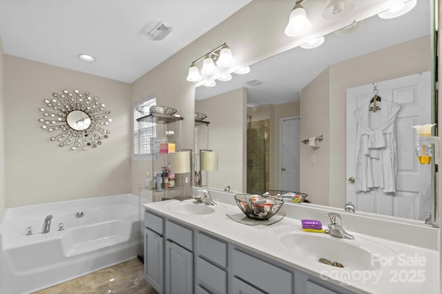 bathroom with a garden tub, double vanity, a sink, and a shower stall