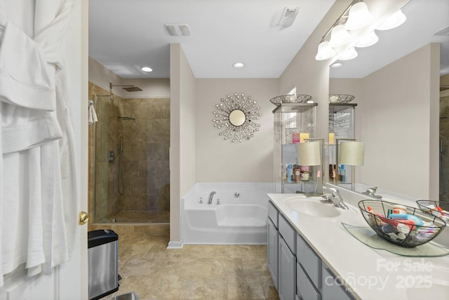 bathroom featuring a garden tub, a shower stall, and vanity