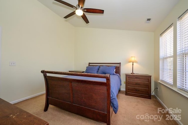 bedroom featuring ceiling fan, light colored carpet, and baseboards