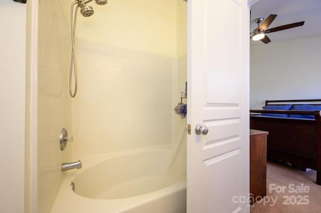 bathroom featuring shower / washtub combination and ceiling fan