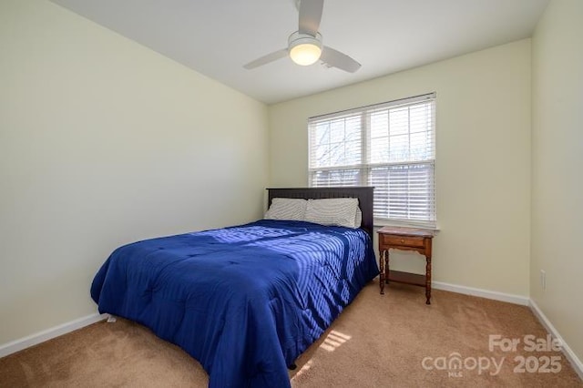 carpeted bedroom with a ceiling fan and baseboards