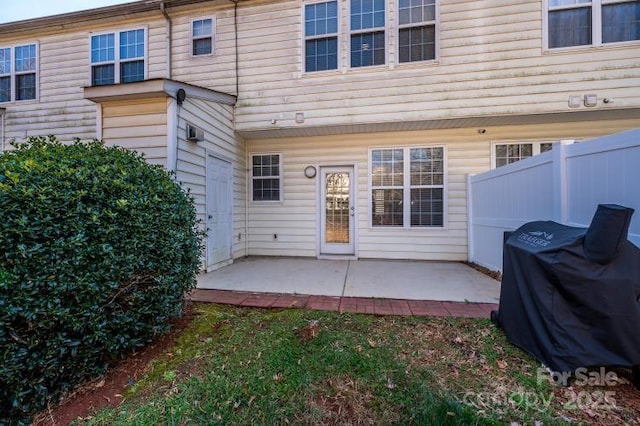 rear view of house with fence and a patio