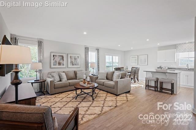 living area with recessed lighting, plenty of natural light, and light wood-style flooring