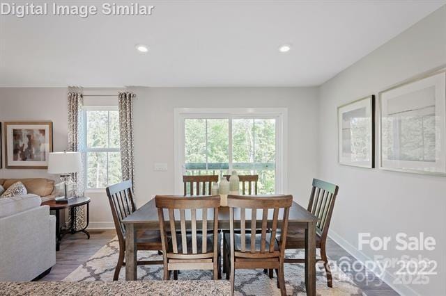 dining room with recessed lighting, baseboards, and wood finished floors