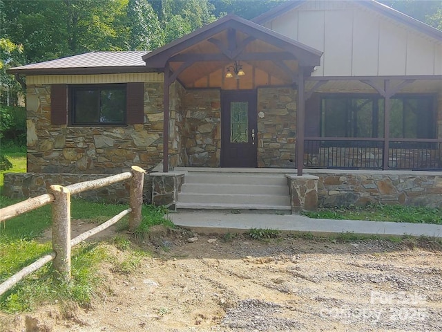 view of front of home featuring stone siding and board and batten siding