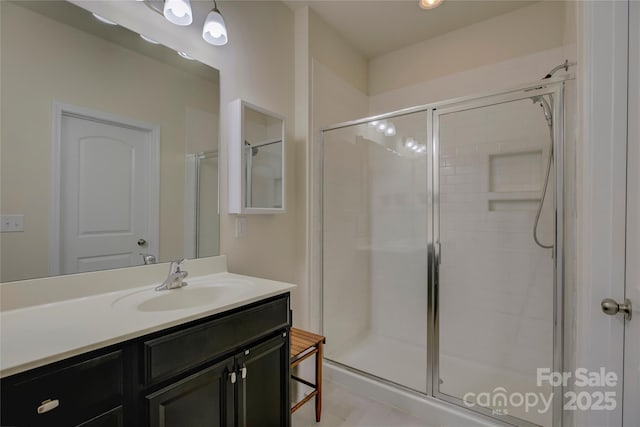 full bath with a shower stall and vanity