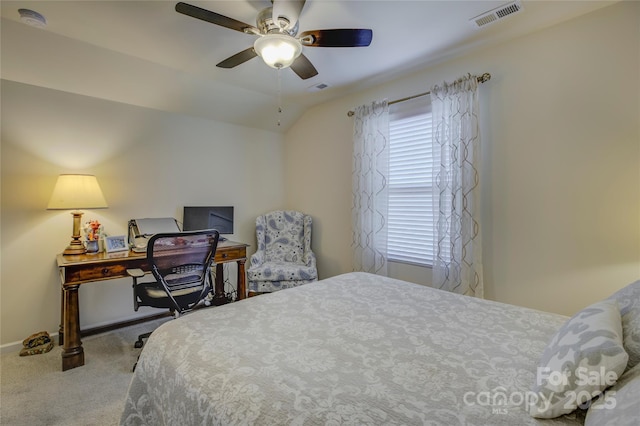 carpeted bedroom with vaulted ceiling, ceiling fan, multiple windows, and visible vents