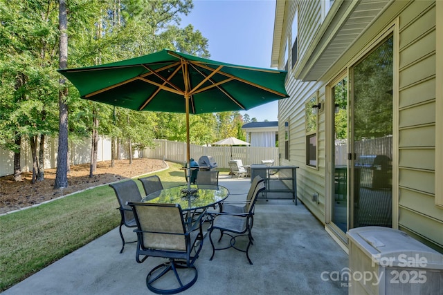 view of patio with outdoor dining area and a fenced backyard