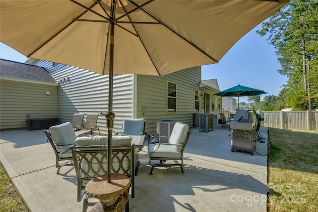 view of patio / terrace with fence and a grill