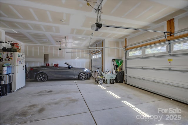 parking deck featuring a garage door opener, freestanding refrigerator, and electric panel