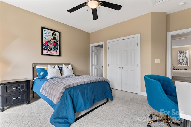 carpeted bedroom featuring a ceiling fan, a closet, and baseboards