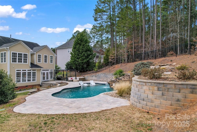 view of pool with a patio, french doors, fence, and a fenced in pool