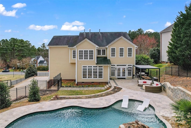 back of property featuring a fenced backyard, french doors, crawl space, a fenced in pool, and a patio area