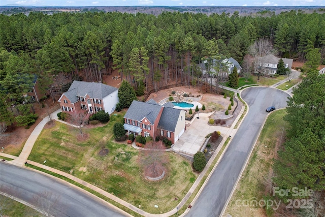 drone / aerial view featuring a forest view