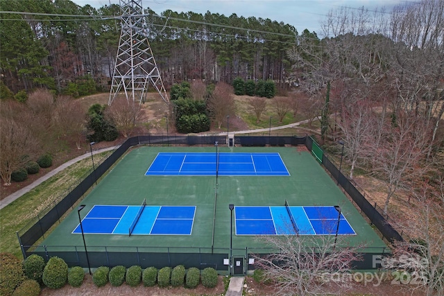 view of tennis court featuring fence