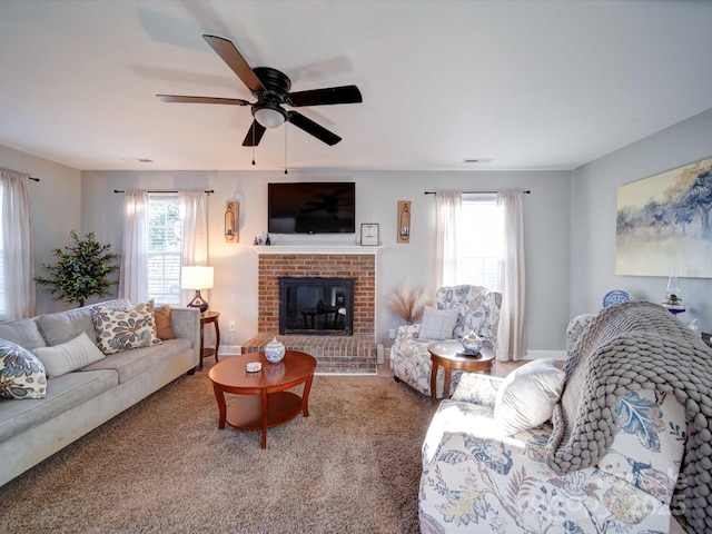 living room with a fireplace, plenty of natural light, carpet flooring, and ceiling fan