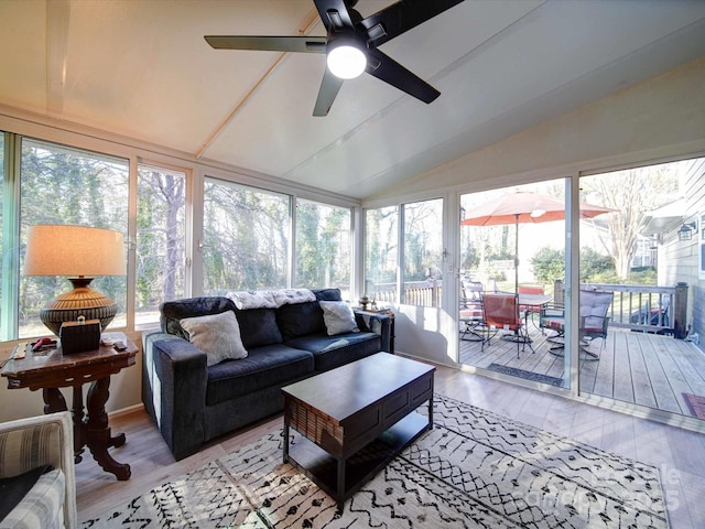 sunroom with lofted ceiling and a ceiling fan