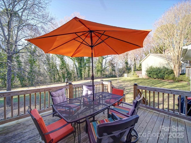 deck featuring a yard and outdoor dining area