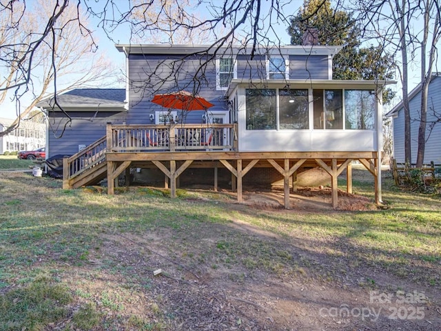 back of house featuring a sunroom and a deck