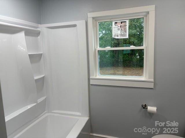 full bath featuring baseboards and bathtub / shower combination