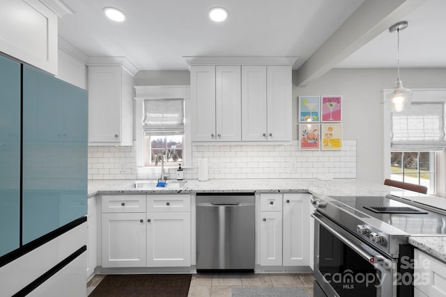 kitchen with a sink, white cabinets, a wealth of natural light, and stainless steel appliances