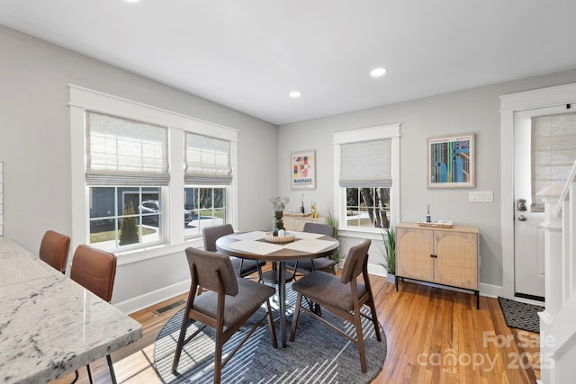 dining room featuring plenty of natural light, visible vents, light wood-type flooring, and baseboards