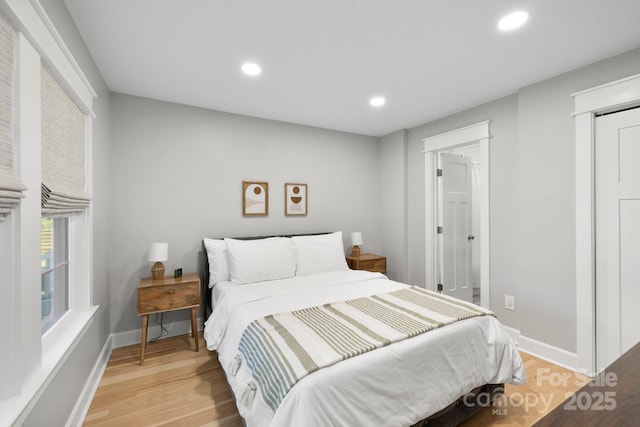 bedroom with light wood finished floors, recessed lighting, and baseboards