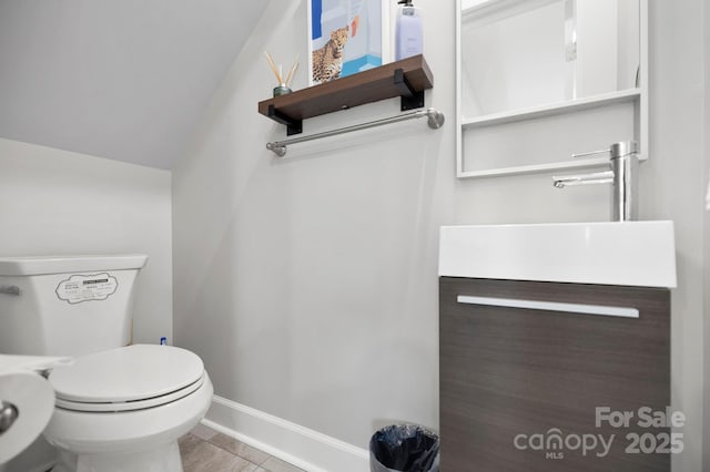 half bathroom featuring baseboards, toilet, lofted ceiling, and vanity