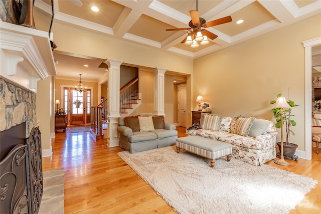 living room featuring light wood-style floors, decorative columns, stairway, and coffered ceiling