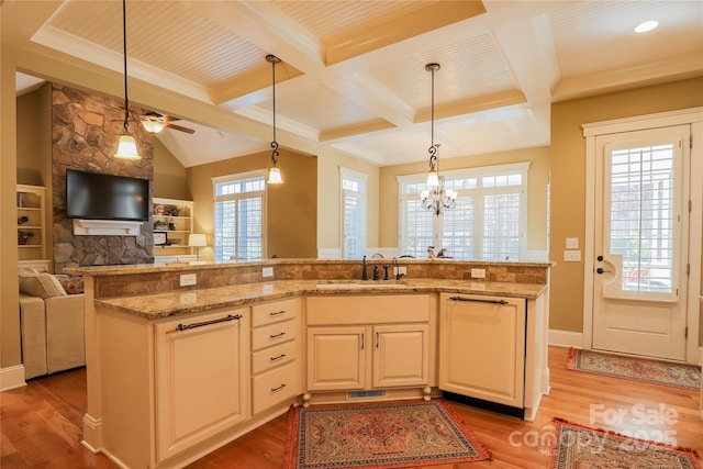 kitchen with light stone countertops, light wood-style floors, and open floor plan