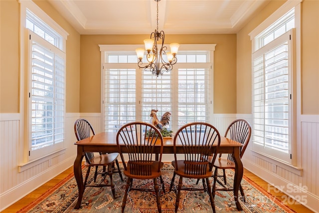 dining space with a wainscoted wall and plenty of natural light