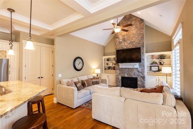 living area with ceiling fan, dark wood-type flooring, a fireplace, high vaulted ceiling, and beam ceiling