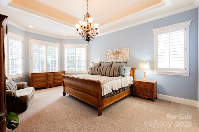 bedroom with baseboards, light colored carpet, ornamental molding, a tray ceiling, and a chandelier