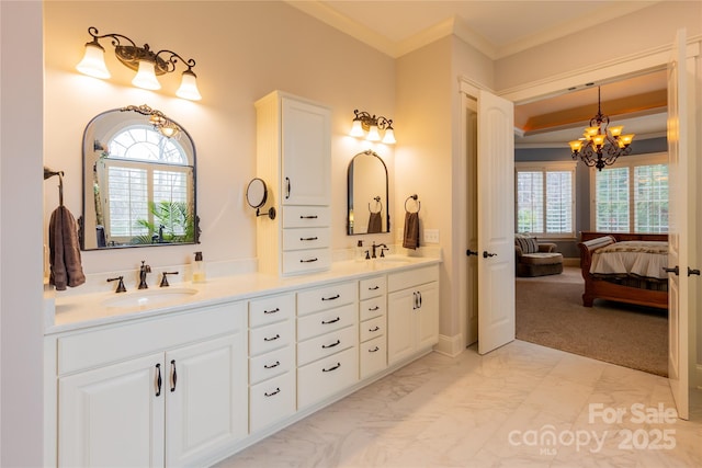 ensuite bathroom with ornamental molding, marble finish floor, a sink, and double vanity