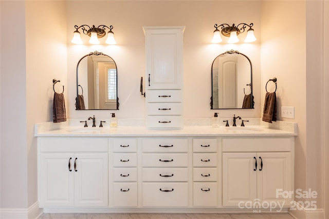 bathroom featuring double vanity and a sink