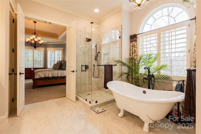 bathroom featuring connected bathroom, marble finish floor, a freestanding bath, a shower stall, and a chandelier